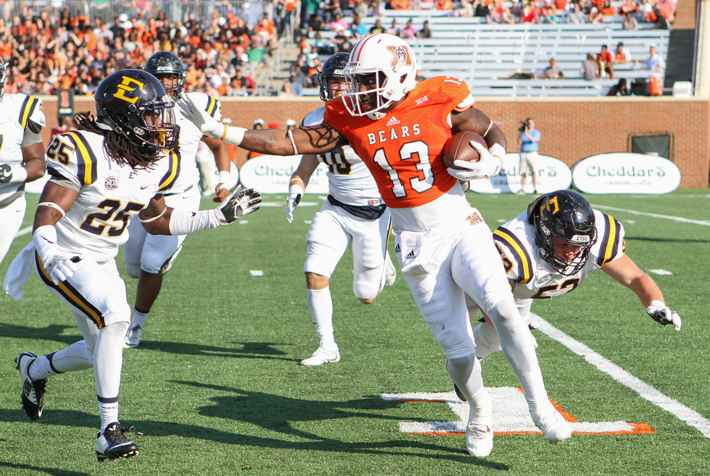 Mercer Running Back stiff arms a defender